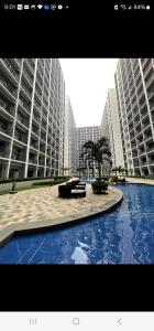 a large building with a palm tree in front of it at Mitch serene shore in Manila