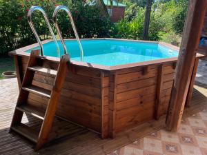 a hot tub with a chair in front of it at Maison Nature in Le Moule