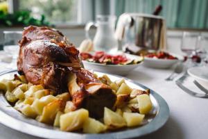a plate of food with a turkey and potatoes on a table at Hotel Royal in Giulianova