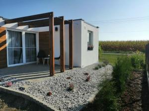 a house with a patio with a table and chickens on it at Domek POD LASEM in Opole