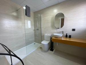 a bathroom with a shower and a toilet and a sink at LHOME CÁDIZ in Cádiz