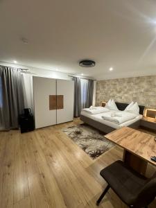 a large living room with a bed and a table at Pension Alpina in Roppen +68 photos