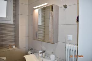 a bathroom with a sink and a mirror at Anatoli's house in Kastoria +39 photos