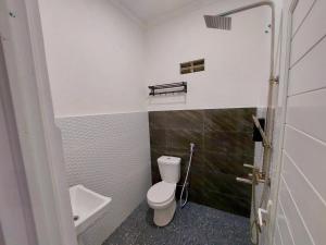 a small bathroom with a toilet and a sink at Yustien Homestay Jogja 3 Bedroom - Entire House in Bantul +25 photos