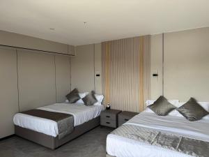 Postel nebo postele na pokoji v ubytování Taufusi Hotel