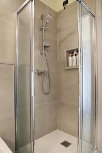 a shower with a glass door in a bathroom at Stelle di Verona - Selene in Verona