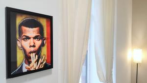 a framed picture of a man withcigarettes gmaxwell gmaxwell gmaxwellythonythonythonythonython at Le Cocon Studio in Brussels