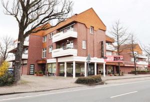 a large brick building on the side of a street at Auszeit in Bad Zwischenahn