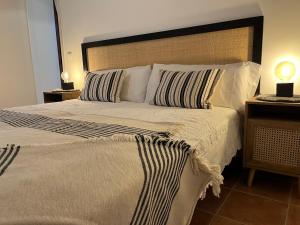 a bedroom with a large bed with a large headboard at Ulls del Priorat in Masroig