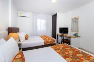 Postel nebo postele na pokoji v ubytování Hotel Playa Club