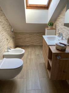 a bathroom with two sinks and a toilet at Calisio, Trentino in Civezzano +25 photos