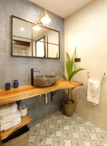 a bathroom with a sink and a mirror at Casa Rural El Ribero II in Montiano de Mena +25 photos