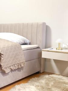 a bedroom with a bed and a side table at Elegantes City-Apartment im Herzen von Bad Mergentheim in Bad Mergentheim