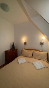 a bedroom with a bed with two towels on it at Apartmani Čardaci Kopaonik in Kopaonik