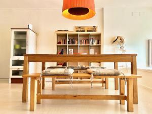 a wooden bench with pillows on it in a room at Luxury Duplex - 2 Terraces - Private Beach in Tossa de Mar