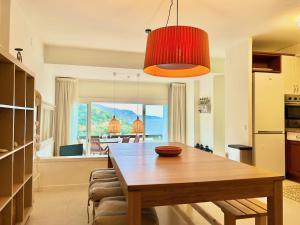 a kitchen and dining room with a wooden table at Luxury Duplex - 2 Terraces - Private Beach in Tossa de Mar