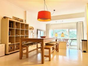 a dining room with a wooden table and benches at Luxury Duplex - 2 Terraces - Private Beach in Tossa de Mar +30 photos