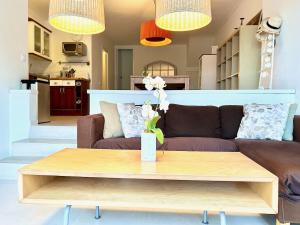 a living room with a couch and a coffee table at Luxury Duplex - 2 Terraces - Private Beach in Tossa de Mar