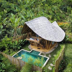 an aerial view of a hut with a swimming pool at Bamboo House - Ecobreeze in Sidemen