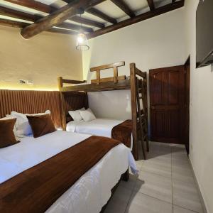 a hotel room with two beds at La Toscana Hostel in Villa de Leyva