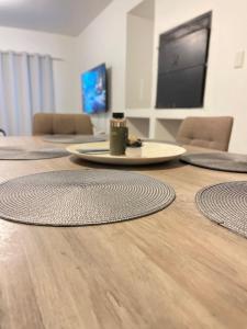 a room with a table with a surfboard on the floor at Hilo Family Accomodation in Swakopmund