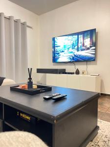 a living room with a tv and a table at Hilo Family Accomodation in Swakopmund