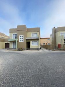 an empty parking lot in front of a house at Hilo Family Accomodation in Swakopmund