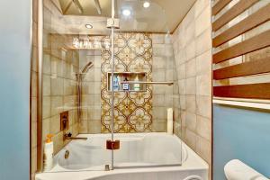 a bathroom with a large tub in a room at Neocolonial Nouveau Kensington Vacation Home in Vancouver +40 photos