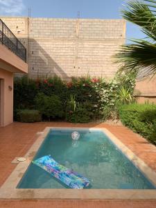 a small swimming pool in a yard with a building at Locanda House, Marrakech Sidi Ghiat in Marrakech