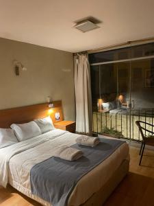 a bedroom with a large bed and a balcony at Hotel Piru Wasi in Arequipa +41 photos