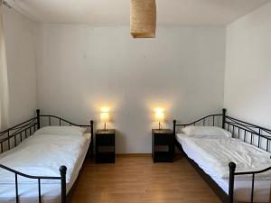 two beds in a room with two lamps on them at Düsseldorf 1995 in Düsseldorf