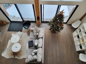 a living room with a christmas tree and a couch at Nomade A unique experience in the heart of nature in Grande Vallee