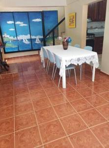 a dining room with a white table and chairs at Home away from Home in La Villa Isabela in La Isabela +17 photos