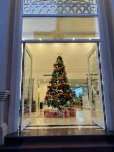 a christmas tree in a mall with a window at Cat Ba Wonder Hotel in Cat Ba