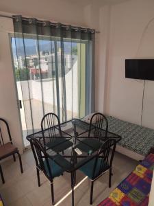 a room with a table and chairs and a balcony at Departamento Acapulco tres mares in Acapulco