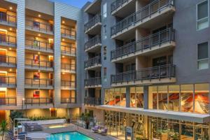 an image of an apartment building with a swimming pool at Luxury Penthouse Loft w POOL GYM AMERICANA in Glendale