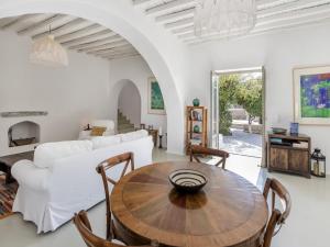 a living room with a table and a white couch at Traditional villa with swimming pool in Ano Mera +32 photos