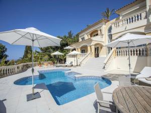 a villa with a swimming pool and a house at Villa in Port d'Andratx with Panoramic Views in Andratx