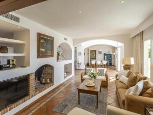 a living room with a couch and a fireplace at Villa in Port d'Andratx with Panoramic Views in Andratx