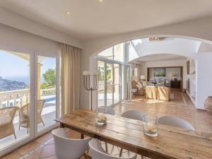 a dining room with a wooden table and chairs at Villa in Port d'Andratx with Panoramic Views in Andratx