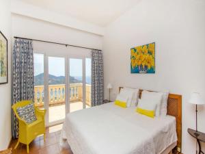 a bedroom with a bed and a balcony at Villa in Port d'Andratx with Panoramic Views in Andratx +32 photos