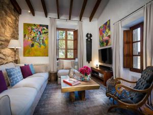 a living room with a couch and a table at Traditional villa with private pool in Banyalbufar