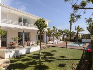 an exterior view of a house with a yard at Villa in Ibiza with Pool near Cala Bassa Beach in San Antonio