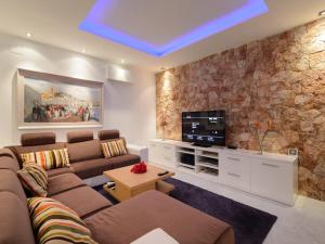a living room with a couch and a tv at Villa in Ibiza with Pool near Cala Bassa Beach in San Antonio