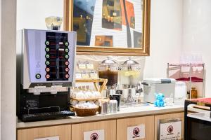 a kitchen with a counter with a coffee machine at Hotel Sobial Osaka Dome in Osaka