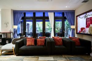 a living room with a couch and a large window at Hotel Sobial Osaka Dome in Osaka