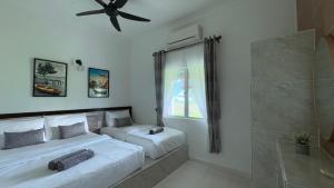 Postel nebo postele na pokoji v ubytování DVilla Guesthouse Langkawi