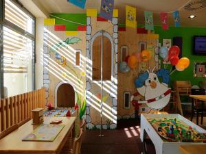 a classroom with a playroom with a santa claus wall at Hotel Draganic in Draganići