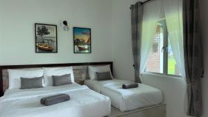 Postel nebo postele na pokoji v ubytování DVilla Guesthouse Langkawi