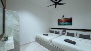 Postel nebo postele na pokoji v ubytování DVilla Guesthouse Langkawi